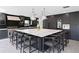Modern kitchen with large island, marble countertops, and dark cabinetry at 2599 W Bay Isle Se Dr, St Petersburg, FL 33705