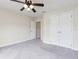 Bright bedroom with double-door closet and ceiling fan at 3027 Aldoro Ave, Spring Hill, FL 34609