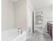 Bathroom featuring garden tub and view into bedroom at 3027 Aldoro Ave, Spring Hill, FL 34609