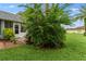 View of a lawn with partial home view, lush bushes, and a paver walkway at 3361 Scorecard Dr # 0, New Port Richey, FL 34655