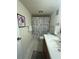 Bathroom with wood vanity and shower with modern curtain at 6060 Shore S Blvd # 705, Gulfport, FL 33707