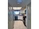 Well-lit kitchen with white cabinets, appliances, and view to the living room at 6060 Shore S Blvd # 705, Gulfport, FL 33707