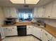 Functional kitchen with white cabinets and modern appliances, offering a practical cooking space at 6060 Shore S Blvd # 705, Gulfport, FL 33707