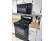 Modern kitchen featuring a gas range, microwave, and white cabinetry for a sleek design at 6060 Shore S Blvd # 705, Gulfport, FL 33707