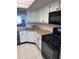 Well-equipped kitchen with white cabinets, gas range, and modern appliances for cooking convenience at 6060 Shore S Blvd # 705, Gulfport, FL 33707