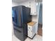 Modern kitchen featuring a stainless steel Samsung refrigerator and white cabinets for a sleek and functional space at 6060 Shore S Blvd # 705, Gulfport, FL 33707
