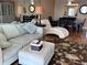 Living room featuring a comfy couch and ottoman at 6060 Shore S Blvd # 705, Gulfport, FL 33707