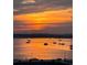 Orange sunset over calm water with boats at 6060 Shore S Blvd # 705, Gulfport, FL 33707