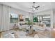 Bright living room with large windows and sliding glass doors leading to a patio at 6157 Dusk Rose Ln, Brooksville, FL 34601