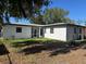 White-painted house with screened porch and AC unit at 6403 Amundson St, Tampa, FL 33634