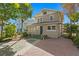 Tan two-story house with a blue door and green steps at 1045 17Th N Ave, St Petersburg, FL 33704