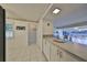 Kitchen with white cabinets and view to living room at 1728 Council Dr, Sun City Center, FL 33573