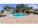 Community pool with lounge chairs and patio tables at 1799 N Highland Ave # 7, Clearwater, FL 33755