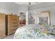 Bedroom with floral bedding and view into adjacent living area at 2403 Nantucket Green Ct # 0, Sun City Center, FL 33573