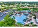 Community pool with surrounding lounge chairs and pickleball courts at 2403 Nantucket Green Ct # 0, Sun City Center, FL 33573