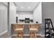 Modern kitchen features white cabinets, stainless steel appliances, and a breakfast bar at 2403 Nantucket Green Ct # 0, Sun City Center, FL 33573