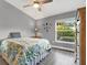 Bright bedroom with a floral bedspread, large window, and ceiling fan at 2403 Nantucket Green Ct # 0, Sun City Center, FL 33573