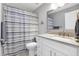 Clean bathroom with updated vanity, shower/tub combo, and patterned curtain at 2403 Nantucket Green Ct # 0, Sun City Center, FL 33573