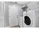 Convenient laundry room with washer, dryer, and extra shelving at 2403 Nantucket Green Ct # 0, Sun City Center, FL 33573