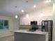 Modern kitchen with island and stainless steel appliances at 2452 Nantucket Ter, North Port, FL 34286