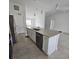 Island kitchen features granite countertops and stainless steel appliances at 2452 Nantucket Ter, North Port, FL 34286