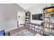 Living area with built-in shelving, a large TV, and a cozy rug at 2937 Bough Ave # D, Clearwater, FL 33760