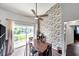 Dining area with wood table and chairs, and a view of the pool from the sliding doors at 2937 Bough Ave # D, Clearwater, FL 33760