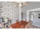 Dining area with a wood table and chairs, adjacent to kitchen and brick feature wall at 2937 Bough Ave # D, Clearwater, FL 33760