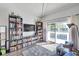 Living room with hardwood floors, built-in shelves, and sliding glass doors to balcony at 2937 Bough Ave # D, Clearwater, FL 33760