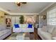 Open living room with white sofas and view of kitchen at 300 Pinellas S Way, St Petersburg, FL 33707