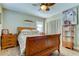 Bedroom with wood sleigh bed, ceiling fan, and wood dresser at 300 Pinellas S Way, St Petersburg, FL 33707