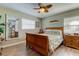 Bright bedroom with a wooden sleigh bed and large mirror at 300 Pinellas S Way, St Petersburg, FL 33707