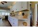 Modern kitchen with white cabinets, stainless steel appliances and hardwood floors at 300 Pinellas S Way, St Petersburg, FL 33707