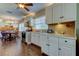 Bright kitchen with white cabinets, stainless steel appliances, and a breakfast nook at 300 Pinellas S Way, St Petersburg, FL 33707