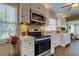 Modern kitchen with white cabinets, a large island, and stainless steel appliances at 300 Pinellas S Way, St Petersburg, FL 33707