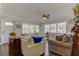 Bright living room with hardwood floors and white sofas at 300 Pinellas S Way, St Petersburg, FL 33707