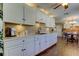 Modern kitchen with white cabinets, stainless steel appliances, and hardwood floors at 300 Pinellas S Way, St Petersburg, FL 33707