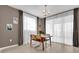Bright dining area with mid-century modern chairs and sheer curtains at 30684 Penny Surf Loop, Wesley Chapel, FL 33545