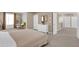 Main bedroom with en-suite bathroom access and an adjacent home office space at 30684 Penny Surf Loop, Wesley Chapel, FL 33545