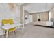 Home office space with a yellow chair and desk, adjacent to a bedroom at 30684 Penny Surf Loop, Wesley Chapel, FL 33545