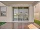 Relaxing patio with wood-like tile flooring and sliding glass doors leading to backyard at 30684 Penny Surf Loop, Wesley Chapel, FL 33545