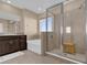 Bathroom features a soaking tub, walk-in shower, and dark brown vanity at 30684 Penny Surf Loop, Wesley Chapel, FL 33545
