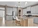 Modern kitchen with gray cabinets, granite counters, and an island at 30684 Penny Surf Loop, Wesley Chapel, FL 33545