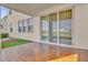 Covered patio with wood-like tile flooring and backyard access at 30684 Penny Surf Loop, Wesley Chapel, FL 33545