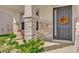 Front porch with stone columns and a red bistro set at 30684 Penny Surf Loop, Wesley Chapel, FL 33545