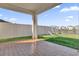 Covered patio overlooking a grassy backyard with playground set and pond view at 30684 Penny Surf Loop, Wesley Chapel, FL 33545