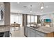 Modern kitchen with island, stainless steel appliances and breakfast nook at 30684 Penny Surf Loop, Wesley Chapel, FL 33545