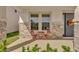 Front porch with stone details, a bistro set and wreath at 30684 Penny Surf Loop, Wesley Chapel, FL 33545