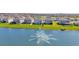 Aerial view of houses with lake and fountain at 30684 Penny Surf Loop, Wesley Chapel, FL 33545