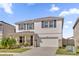 Two-story house with gray shutters and a white garage door at 30684 Penny Surf Loop, Wesley Chapel, FL 33545
